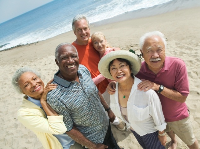 Group of seniors taking selfie on the beach