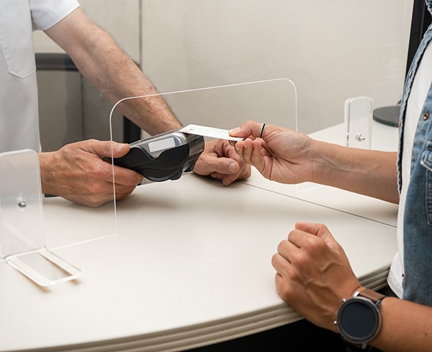 Patient handing over credit card to be charged by medical professional