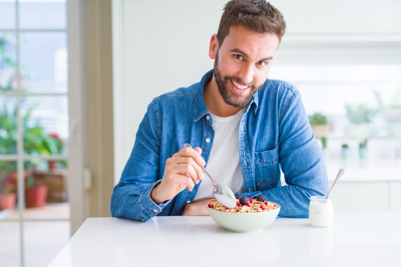 a man with a bright smile enjoying breakfast