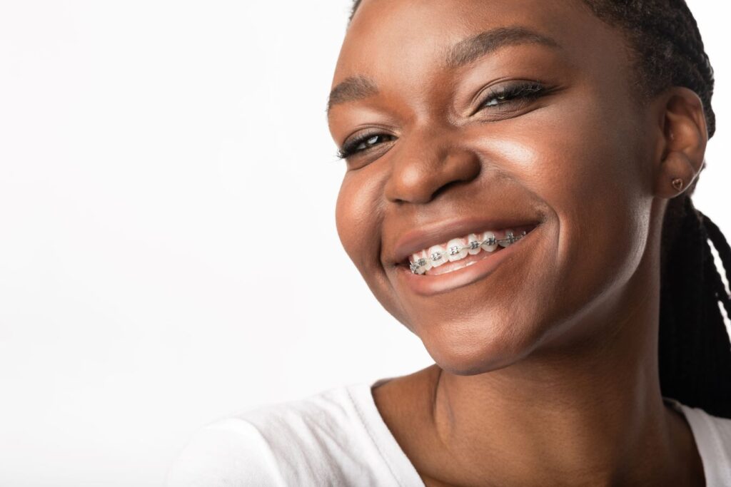 A teenage girl with braces smiling.