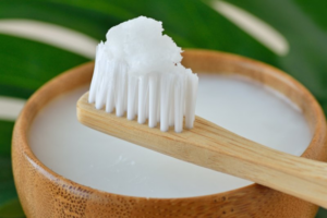 Close up of fancy-looking toothpaste on a bamboo toothbrush