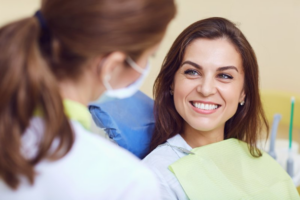 Patient smiling while consulting her dentist